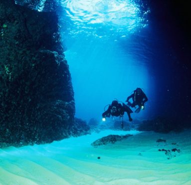 two divers exploring the blue cave